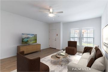 Palm Coast apartment for rent - A living room with a brown chair, a white couch, and a painting on the wall.