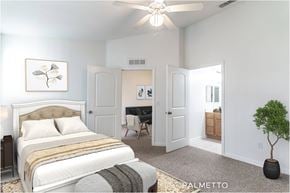Kissimmee townhouse for rent - A bedroom with a large bed and a ceiling fan.