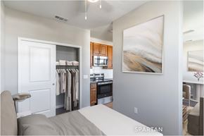 Deland apartment for rent - A bedroom with a large bed and a painting on the wall.