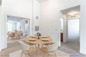 Orlando apartment for rent - A dining room with a table set for six with a view of the kitchen.