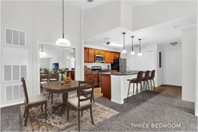 Kissimmee apartment for rent - A kitchen with a table and chairs in the middle of the room.
