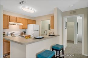 Lady Lake apartment for rent - A kitchen with a bar stool in front of it.