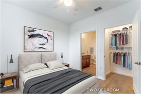 Daytona Beach apartment for rent - A bedroom with a large bed and a painting on the wall.
