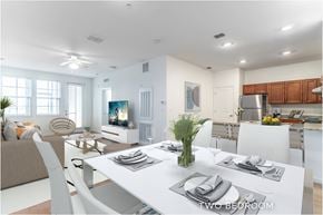 Daytona Beach apartment for rent - A modern dining room with a white table set for two.