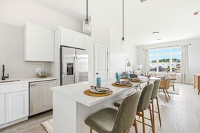 South Dartmouth apartment for rent - A modern kitchen with a dining table set for four.