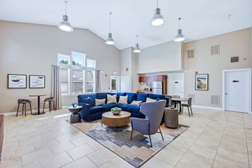 New Bedford apartment for rent - A spacious living room with a blue sofa and a coffee table.