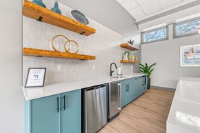 Fall River apartment for rent - A kitchen with blue cabinets and wooden shelves.
