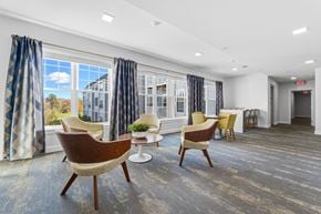 South Dartmouth apartment for rent - A room with a view of a house through the window and a chair in the foreground.