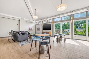 Fall River apartment for rent - A living room with a grey couch, a wooden table, and a television.