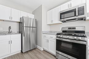 New Bedford apartment for rent - A kitchen with a stainless steel refrigerator, microwave, and oven.