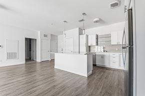 South Dartmouth apartment for rent - A kitchen with white cabinets and a wooden floor.