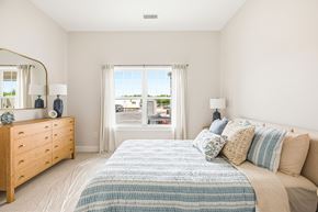 South Dartmouth apartment for rent - A bedroom with a large bed and a dresser with a mirror.