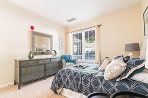 Westwood apartment for rent - A bedroom with a bed, dresser, and mirror.