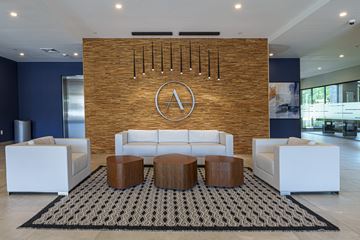 Weymouth apartment for rent - a living room with couches and tables in front of a brick wall