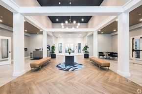 Bridgewater apartment for rent - A spacious lobby with a wooden floor and white columns at Axis at Lakeshore Apartments, Bridgewater, Massachusetts, 02324