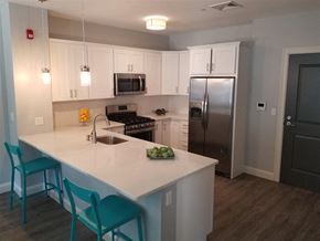 Fall River apartment for rent - a kitchen with a white counter top and a stainless steel refrigerator