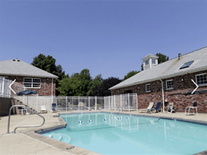 Fall River apartment for rent - a swimming pool in front of a building with a resort style pool