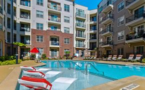 Raleigh apartment for rent - Refreshing Pool with Walk-In Entry and Loungers at The Maggie