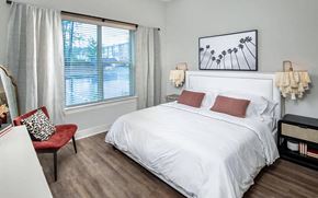 Morrisville apartment for rent - Spacious Bedroom Featuring King Bed, Accent Chair, and Contemporary Decor
