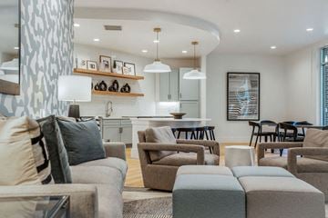 Raleigh apartment for rent - a living room and kitchen with a couch and chairs