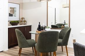 Rancho Cucamonga apartment for rent - Cozy Dining Area with Glass Table, Velvet Chairs, and Accent Mirror