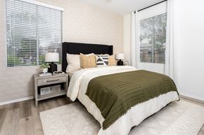Rancho Cucamonga apartment for rent - Luxury Apartments for Rent in Rancho Cucamonga, CA - Camino Real - Bedroom with Hardwood-Style Flooring, Two Large Windows, and a Queen-Sized Bed