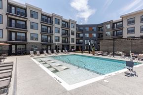 Raleigh apartment for rent - an apartment swimming pool in front of an apartment building