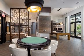 Atlanta apartment for rent - A modern dining room with a glass table surrounded by chairs.