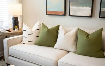 Atlanta apartment for rent - a white couch with green pillows in a living room
