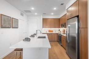 Centennial apartment for rent - A modern kitchen with wooden cabinets and stainless steel appliances.