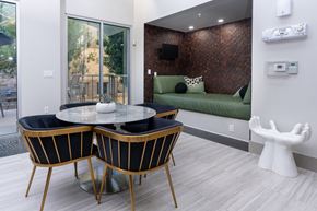 Phoenix apartment for rent - A modern dining room with a glass table and chairs.