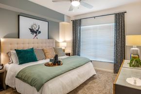 Pembroke Pines apartment for rent - A bedroom with a large bed and a vanity table.