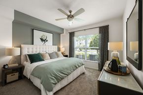 Pembroke Pines apartment for rent - A bedroom with a large bed and a ceiling fan.