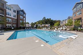 Cary apartment for rent - A large swimming pool surrounded by apartment buildings.