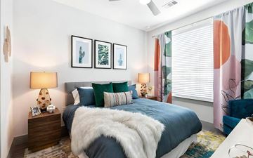 Austin apartment for rent - a bedroom with a bed and a large window