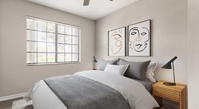 Palm Beach Gardens apartment for rent - A bedroom with a bed, nightstand, and two framed artworks on the wall.