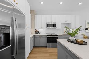 Charlotte apartment for rent - A modern kitchen with a stainless steel refrigerator and wooden flooring.
