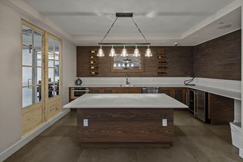 Resident lounge with billiards table, shuffleboard, card room, demonstration kitchen, and more