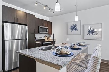 Swampscott apartment for rent - A modern kitchen with a dining table set for two.