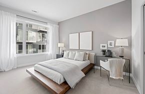 Revere apartment for rent - A bedroom with a large bed and a desk with a chair.