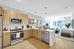Revere apartment for rent - A modern kitchen with wooden cabinets and stainless steel appliances.