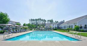 Marshfield townhouse for rent - Long view across the saltwater pool with lounge chairs and landscaped grounds.