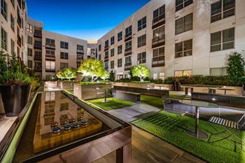 Social courtyard with bocce, ping pong, fire pits, and grills