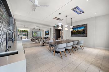 Outdoor loggia with lounge seating, heaters, and tvs