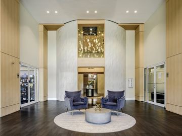 Doral apartment for rent - A modern living room with a circular grey coffee table in the middle.