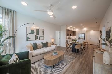 Anaheim apartment for rent - A modern living room with a green couch and a wooden coffee table.