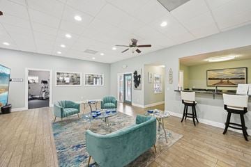 Atlantic Beach apartment for rent - A living room with a blue couch and a painting on the wall.