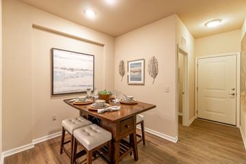 Jacksonville apartment for rent - A dining room with a wooden table and chairs.