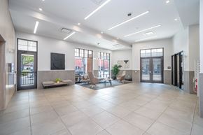 Port Chester apartment for rent - Bright lobby with modern seating and large windows at Port & Main Apartments, New York, 10573