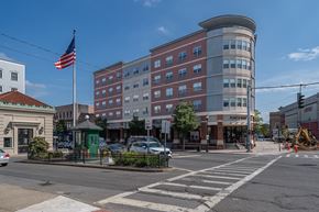 Port Chester apartment for rent - Street view of mixed use building with retail at Port & Main Apartments, Port Chester, New York